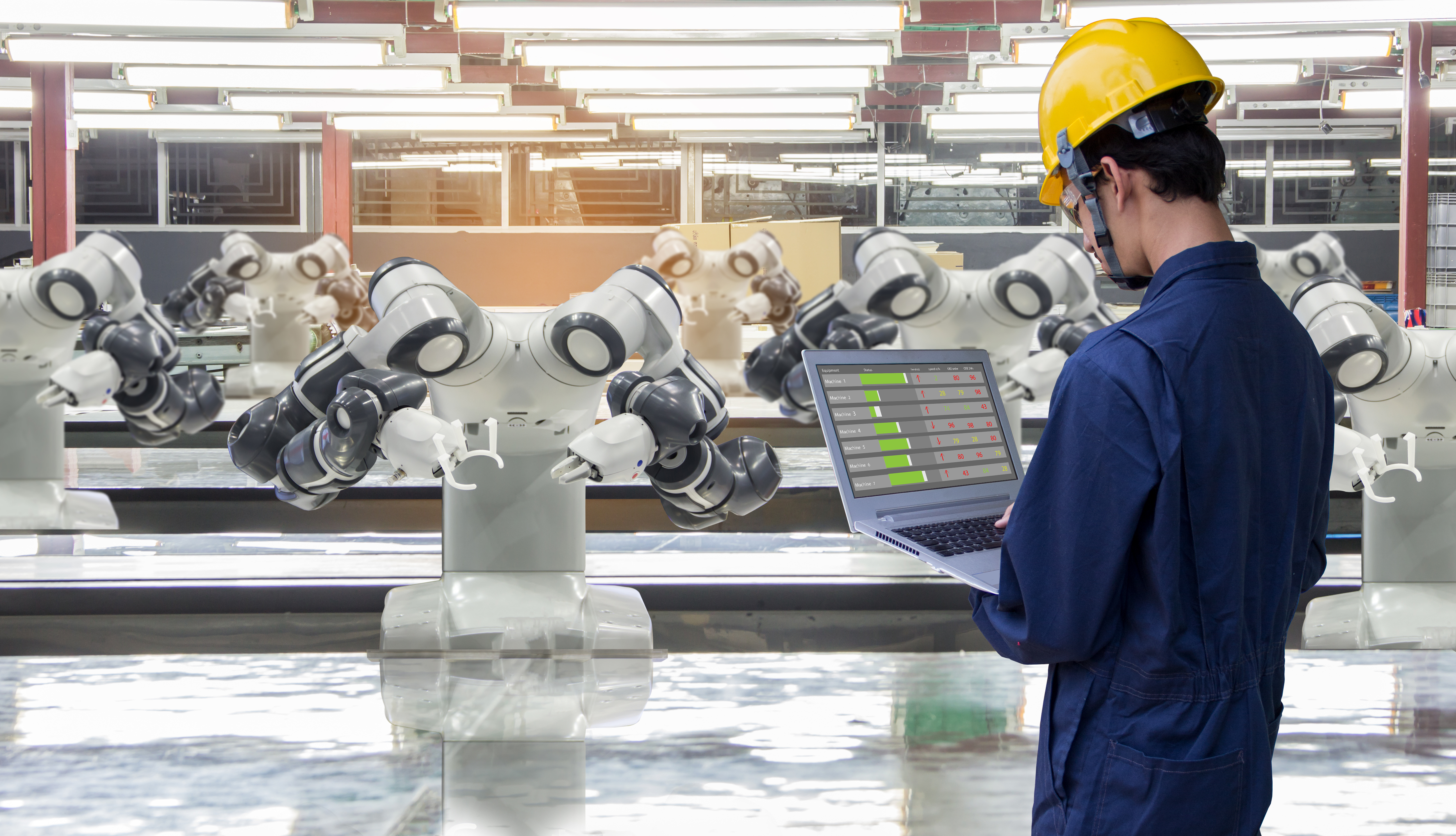 Technician with a laptop in an industrial data center